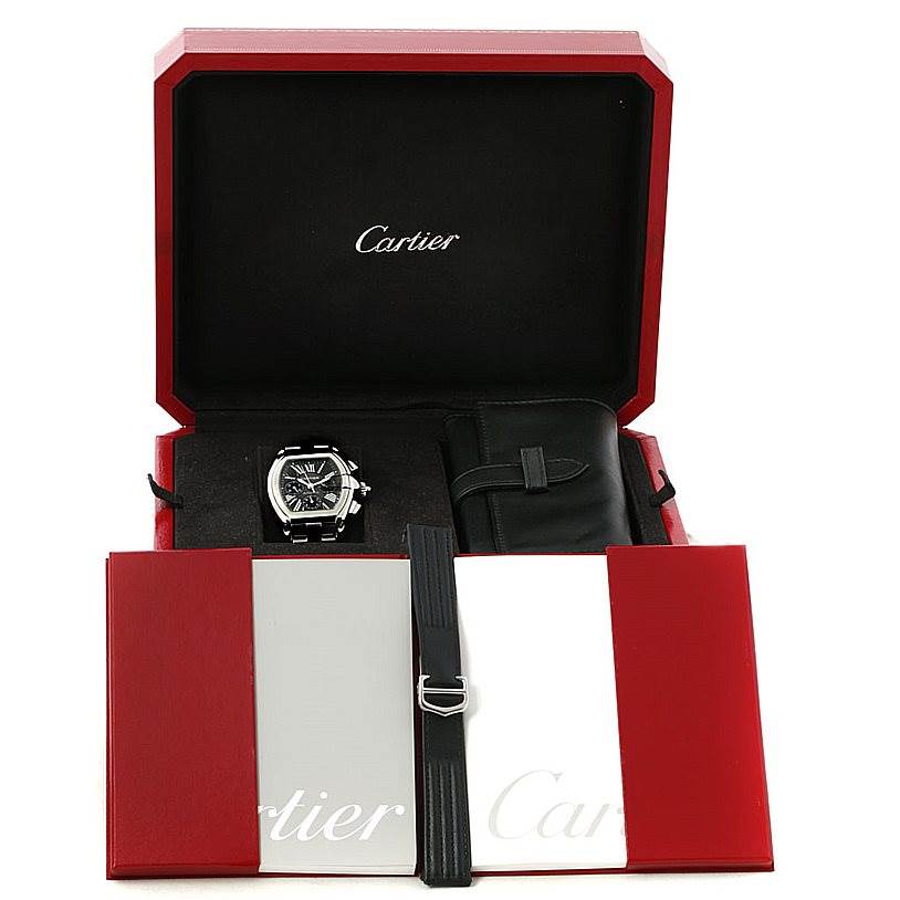 The Cartier Roadster W62020X6 Men's Stainless Steel Black Dial W62020X6 Men's Stainless Steel Black Dial watch is displayed in a red box with accessories, manual, and an extra strap shown.
