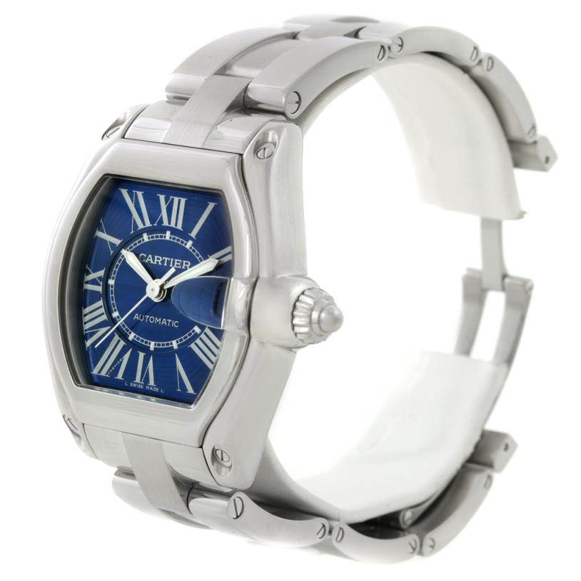 The image shows a Cartier Roadster W62048V3 Men's Stainless Steel Blue Dial W62048V3 Men's Stainless Steel Blue Dial watch from a three-quarter angle, highlighting the face, crown, and part of the bracelet.