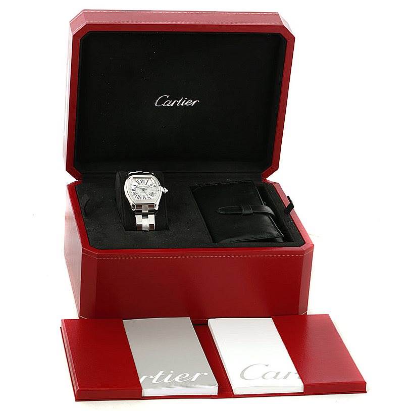 The image shows a Cartier Roadster W62032X6 Men
s Stainless Steel Silver Dial W62032X6 Men
s Stainless Steel Silver Dial watch in an open box, along with packaging and manuals.