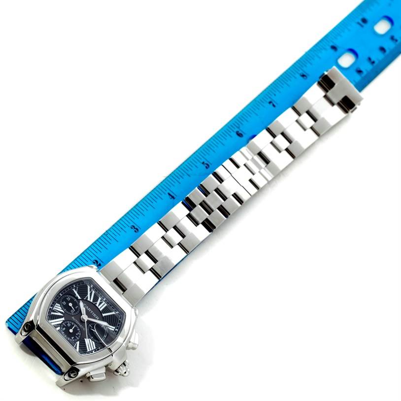 This image shows a top-down view of a Cartier Roadster W62020X6 Men's Stainless Steel Black Dial W62020X6 Men's Stainless Steel Black Dial watch with a ruler measuring its stainless steel bracelet.