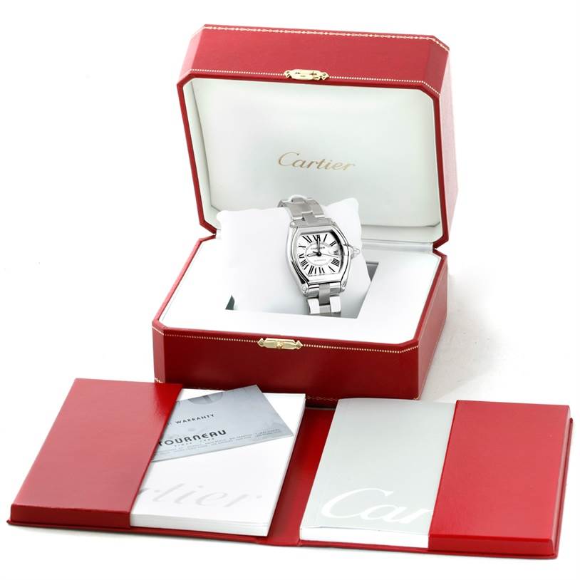 The Cartier Roadster W62025V3 Men
s Stainless Steel Silver Dial W62025V3 Men
s Stainless Steel Silver Dial watch is displayed at a front angle in an open case with accompanying manuals and cards.