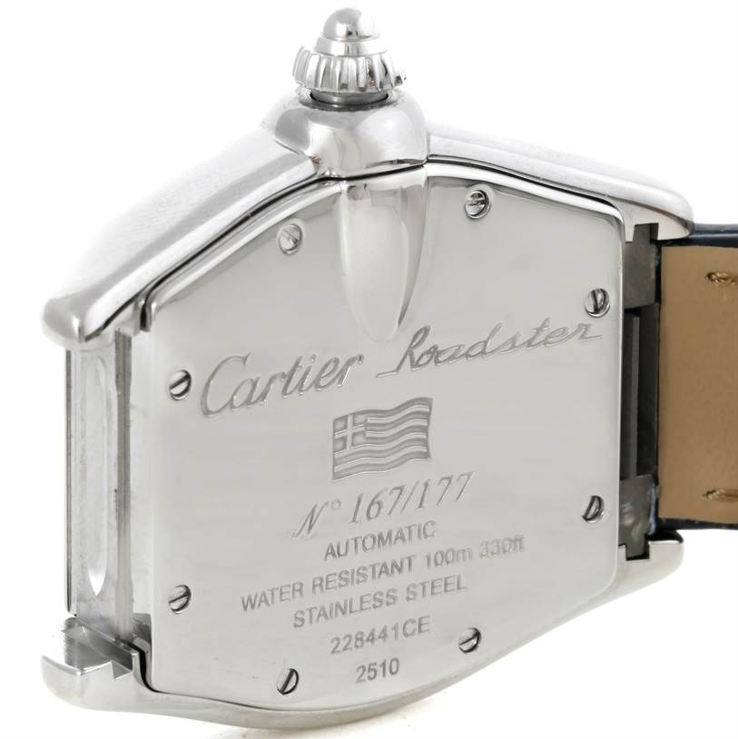 The image shows the back case and crown of a Cartier Roadster W62025V3 Men's Stainless Steel Silver Dial W62025V3 Men's Stainless Steel Silver Dial watch, highlighting its engravings and materials.