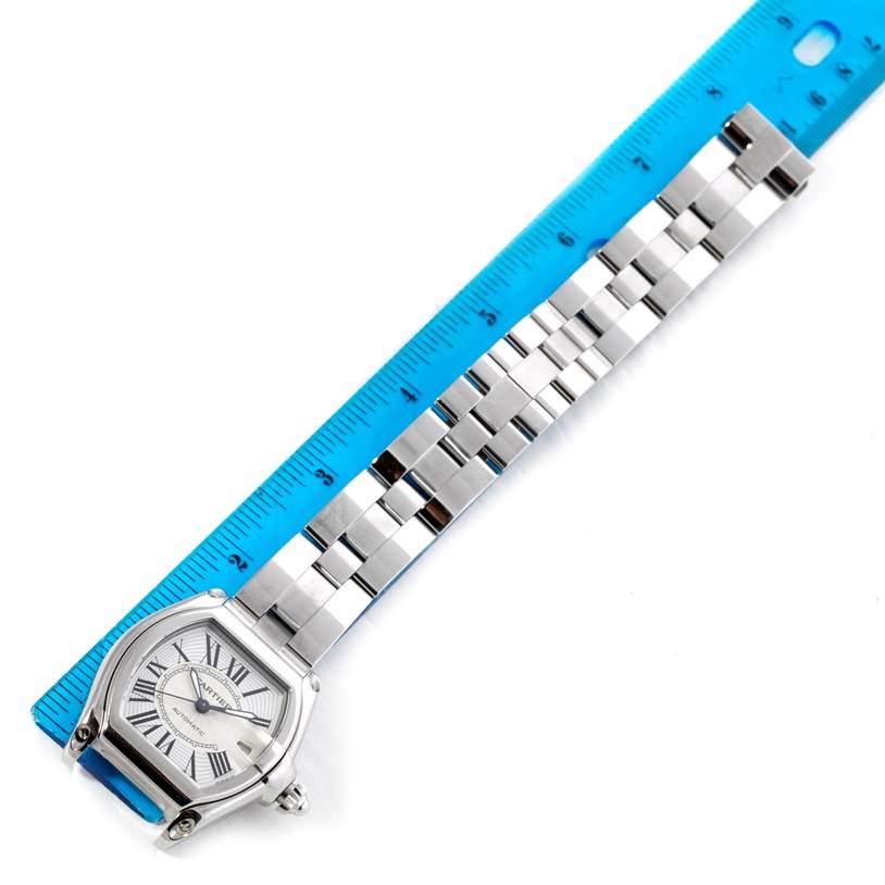 The image shows the face and bracelet of a Cartier Roadster W62025V3 Men's Stainless Steel Silver Dial W62025V3 Men's Stainless Steel Silver Dial watch, laid out next to a blue ruler for measuring.