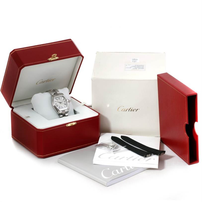 The image shows a Cartier Roadster W62025V3 Men's Stainless Steel Silver Dial W62025V3 Men's Stainless Steel Silver Dial watch in its box, with additional accessories and packaging, from a front angle.