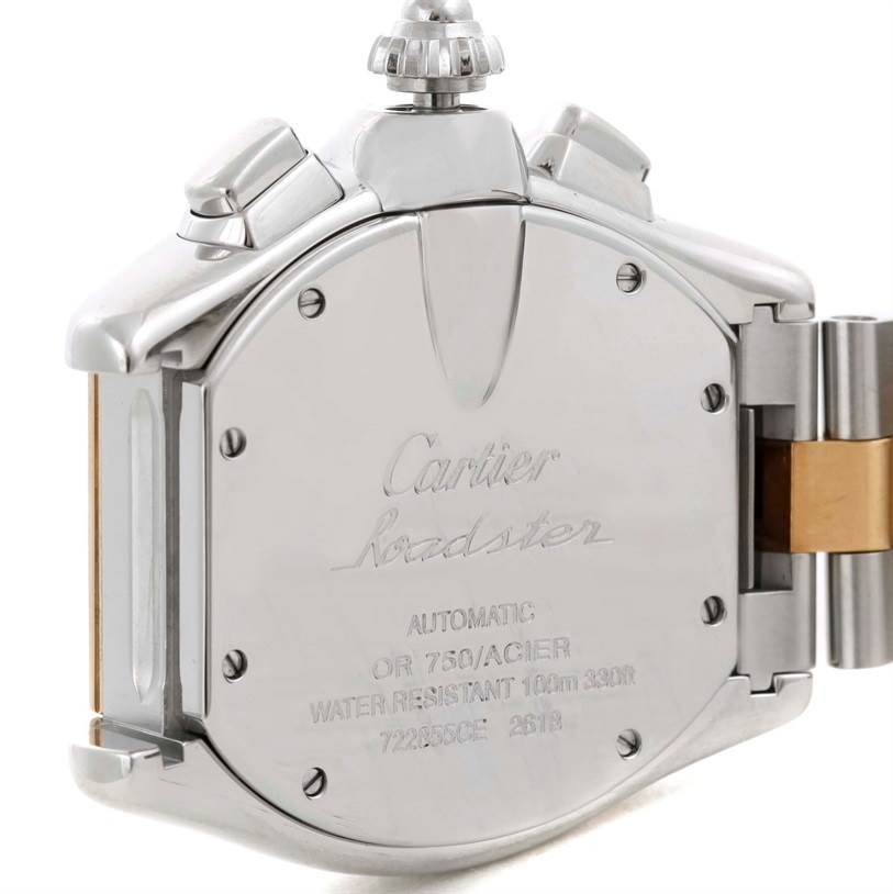 The image shows the back case of a Cartier Roadster W62027Z1 Men's Steel and Gold (two tone) Silver Dial W62027Z1 Men's Steel and Gold (two tone) Silver Dial watch, highlighting the engraved text and crown.