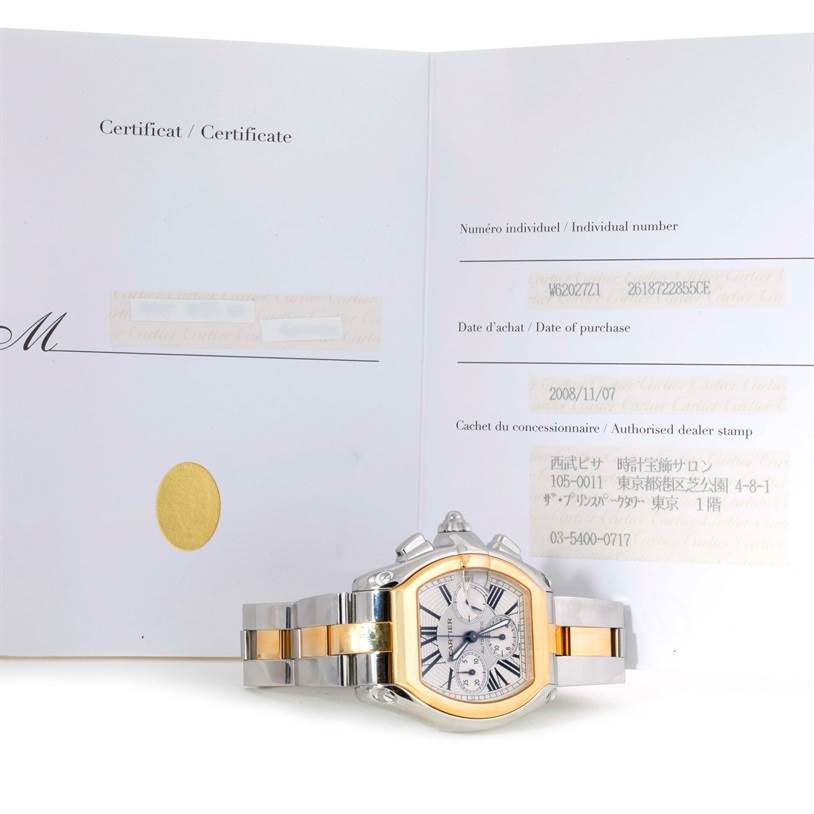 The Cartier Roadster W62027Z1 Men's Steel and Gold (two tone) Silver Dial W62027Z1 Men's Steel and Gold (two tone) Silver Dial watch is shown from a frontal angle, partially on top of its certificate.