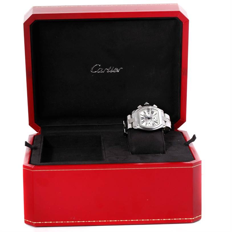 The image shows a Cartier Roadster W62019X6 Men's Stainless Steel Silver Dial W62019X6 Men's Stainless Steel Silver Dial watch placed in an open red Cartier box, featuring the watch face and bracelet.