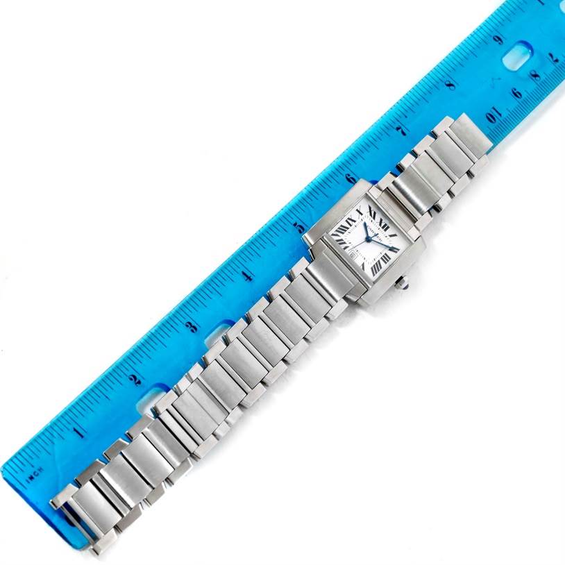 The Cartier Tank Francaise W51002Q3 Men
s Stainless Steel Silver Dial W51002Q3 Men
s Stainless Steel Silver Dial watch is shown lying flat with its face and full metal bracelet visible, alongside a blue ruler.