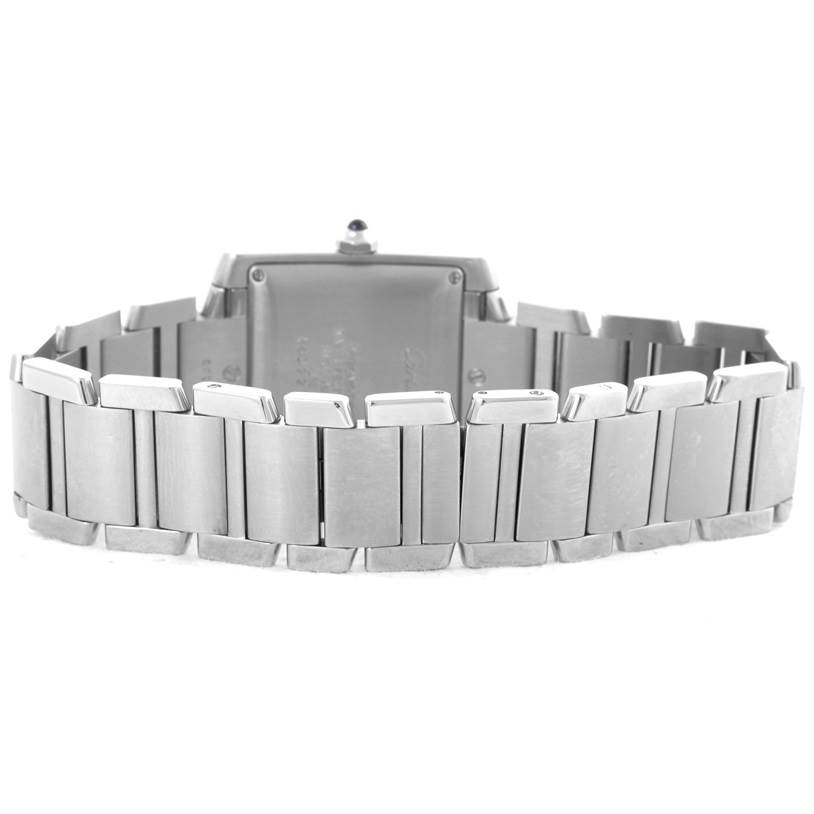 The image shows the back view of the Cartier Tank Française watch, focusing on the metal bracelet and case back.