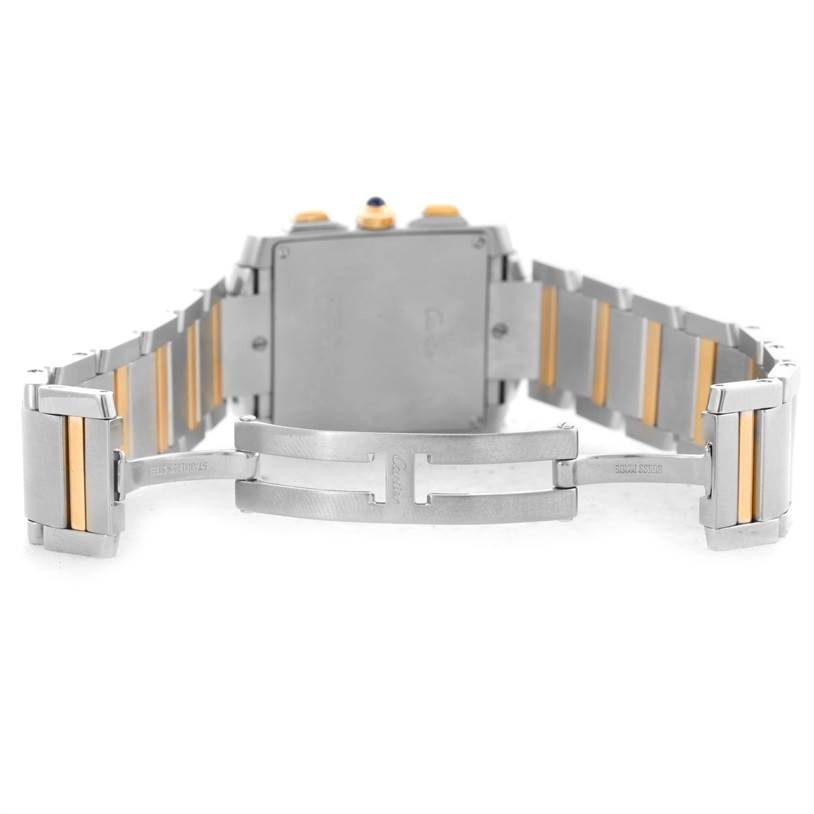 The image shows the back view of a Cartier Tank Française watch with its unfolded metal bracelet featuring gold accents.