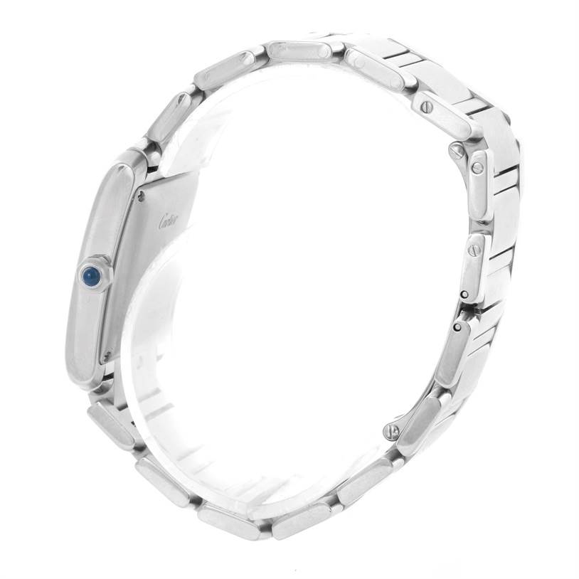 The image shows a Cartier Tank Française watch from a side angle, highlighting the bracelet and crown with a blue cabochon.