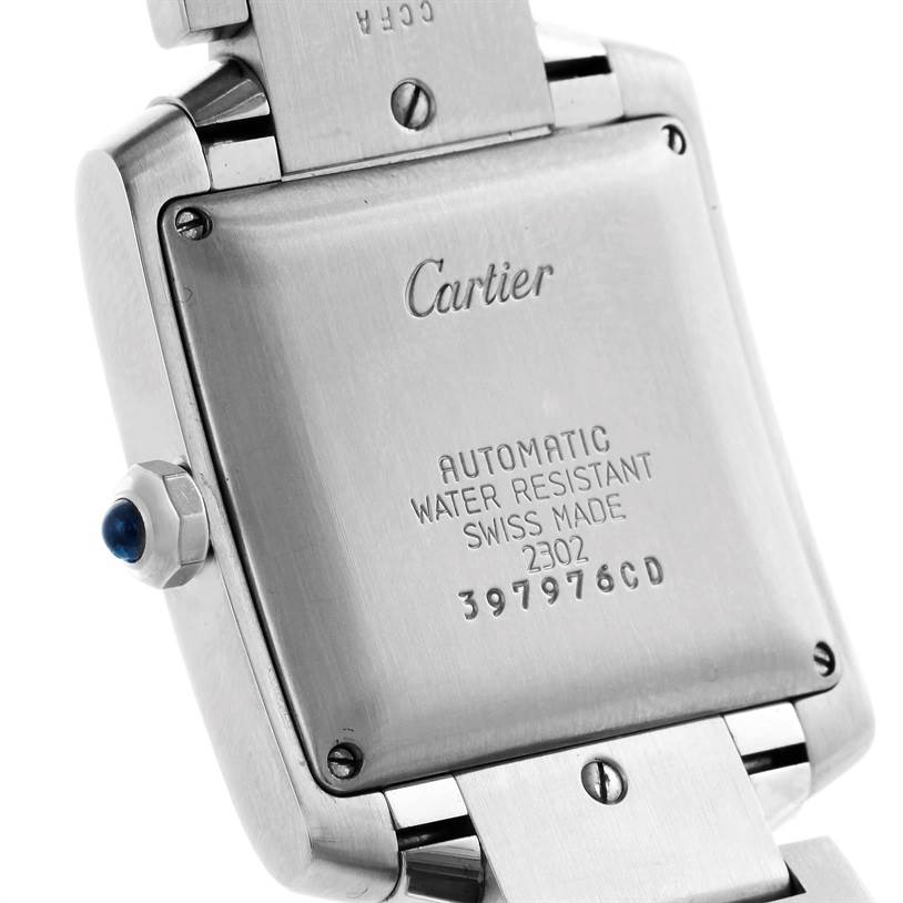 The image shows the back side of a Tank Française watch by Cartier, highlighting the case back details and part of the bracelet.