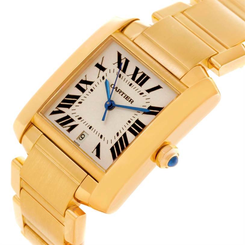 The image shows a close-up angled view of the Cartier Tank Francaise W50001R2 Men's Yellow Gold Silver Dial W50001R2 Men's Yellow Gold Silver Dial watch, highlighting its gold case, bracelet, and blue hands.