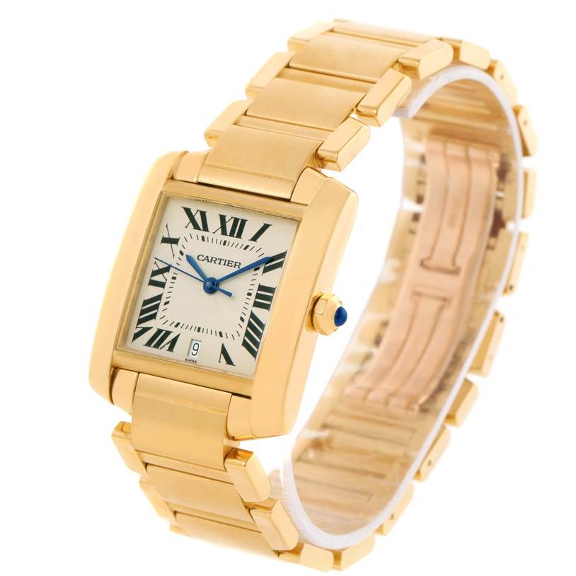 The Cartier Tank Française watch is shown at a slight angle, displaying its gold bracelet, square face, blue hands, and sapphire crown.