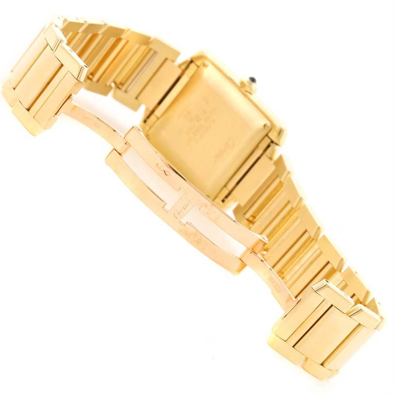 This image shows the back and clasp of a gold Cartier Tank Française watch.