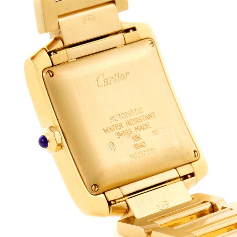 The image shows the back case and part of the bracelet of a Cartier Tank Francaise W50001R2 Men's Yellow Gold Silver Dial W50001R2 Men's Yellow Gold Silver Dial watch, highlighting the inscriptions and clasp.