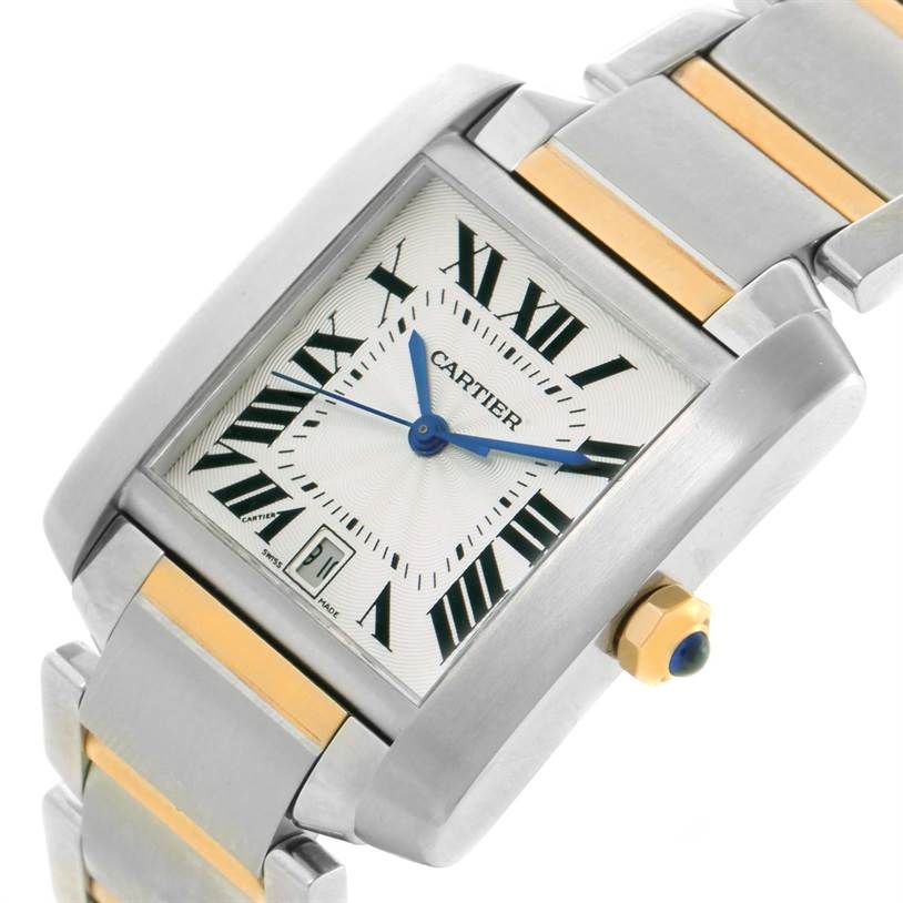 The image shows a Cartier Tank Française watch at an angle highlighting the dial, blue hands, crown, and part of the two-tone bracelet.