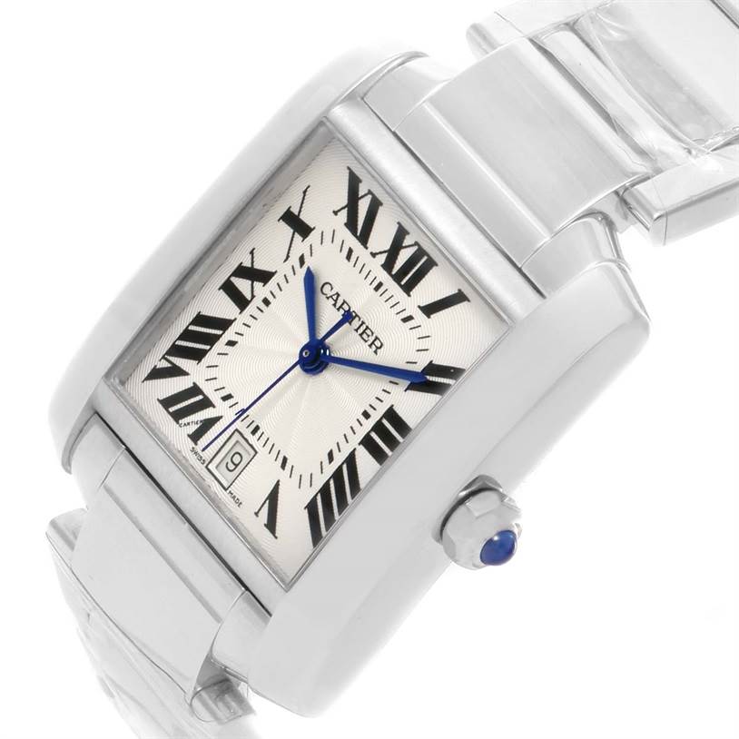 The image shows a Cartier Tank Française watch at an angled view, highlighting the face, Roman numerals, blue hands, crown, and part of the bracelet.