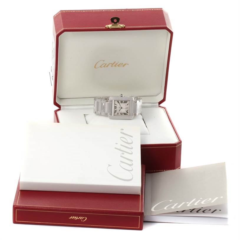 The Cartier Tank Francaise W50011S3 White Gold Silver Dial W50011S3 White Gold Silver Dial watch is displayed in an open red box with accompanying manuals and paperwork.