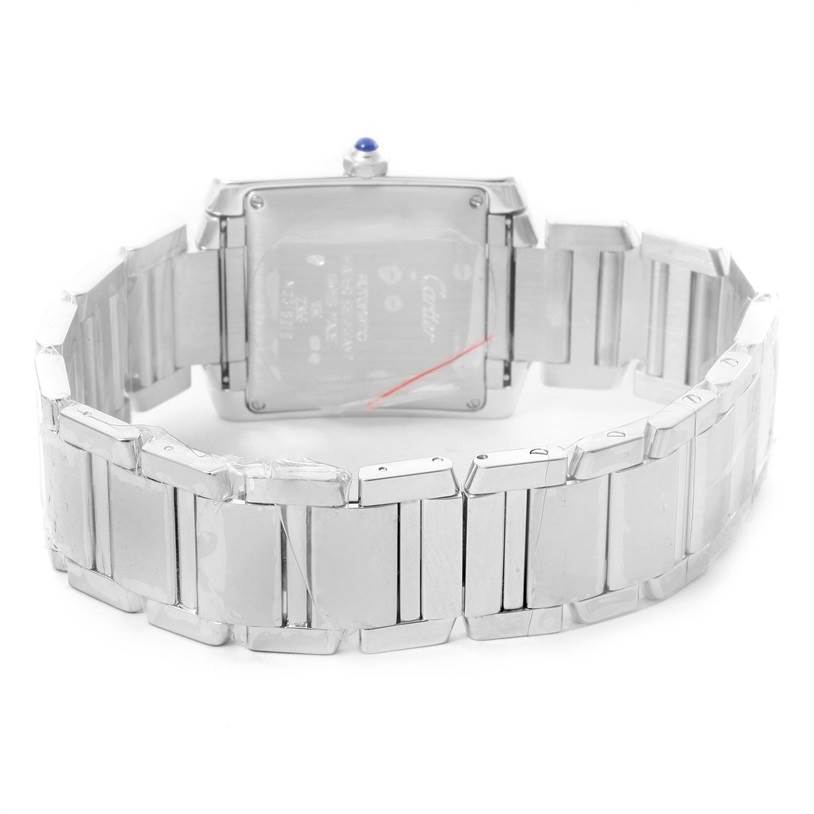 The image shows the back of a Cartier Tank Française watch and its stainless steel bracelet.
