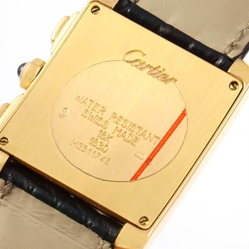 This image shows the back of a Cartier Tank Francaise W5000556 Men
s Yellow Gold Silver Dial W5000556 Men
s Yellow Gold Silver Dial watch, highlighting its inscriptions and leather strap.