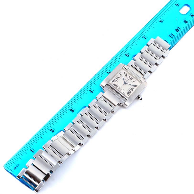 The Cartier Tank Francaise W51002Q3 Stainless Steel Silver Dial W51002Q3 Stainless Steel Silver Dial watch is shown in a top-down view with its stainless steel strap alongside a blue ruler for scale.