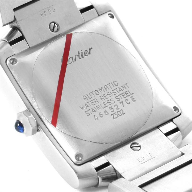 This image shows the back casing of a Cartier Tank Française watch, highlighting its engravings and stainless steel material.
