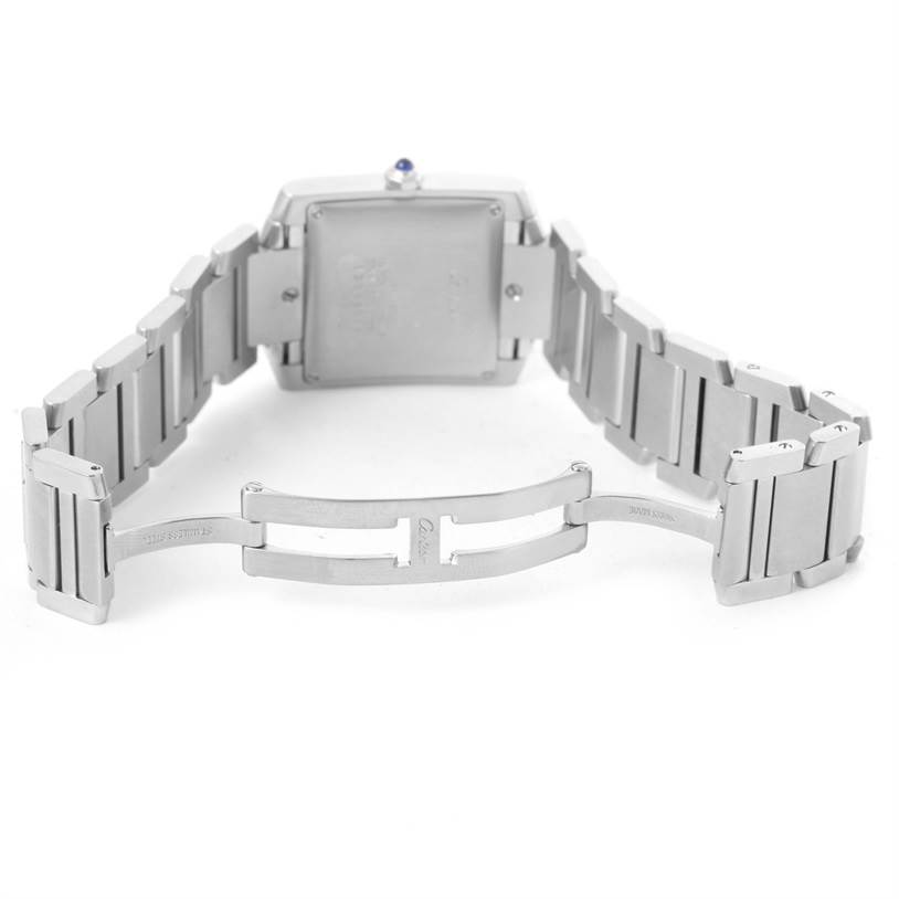 The image shows the back of a Tank Francaise by Cartier, highlighting the square case, bracelet, and deployment clasp.