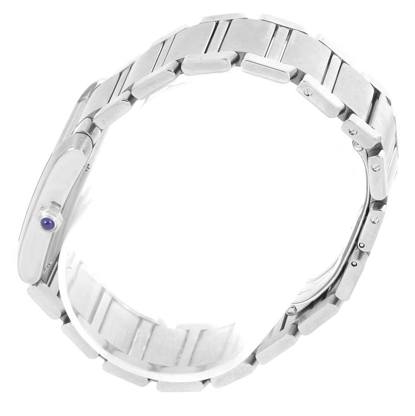 The image shows a side view of a Tank Francaise watch by Cartier, highlighting its metal bracelet and the crown with a blue cabochon.
