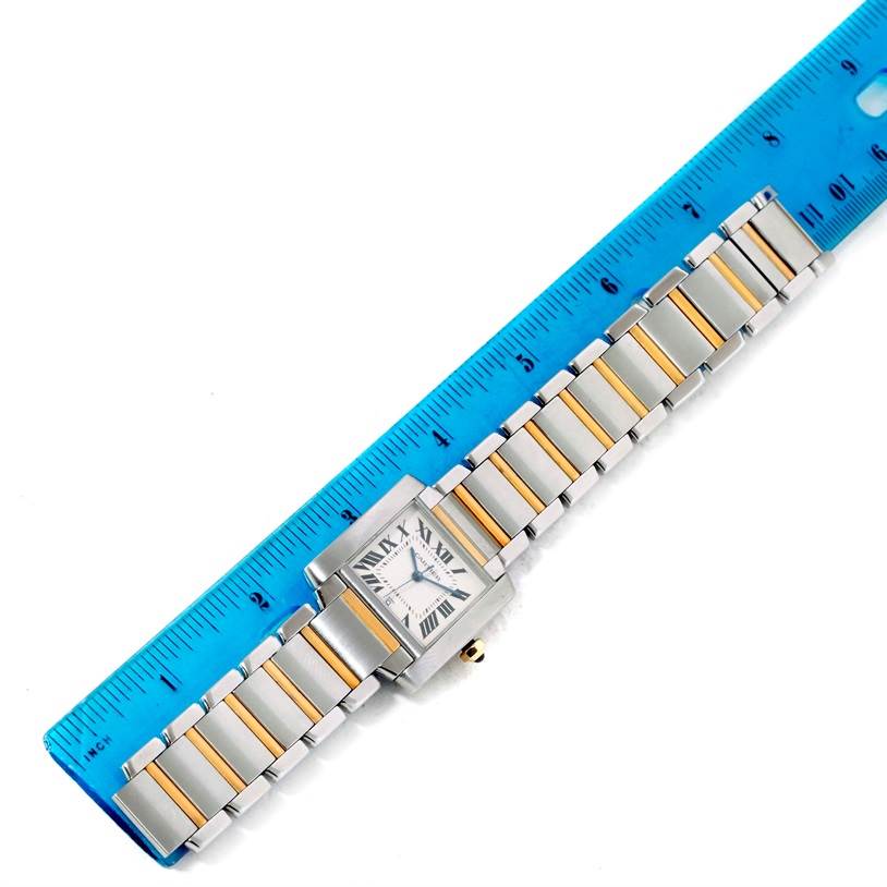 The image shows a Cartier Tank Francaise W51005Q4 Men
s Steel and Gold (two tone) Silver Dial W51005Q4 Men
s Steel and Gold (two tone) Silver Dial watch positioned next to a ruler, displaying the face and two-tone bracelet.