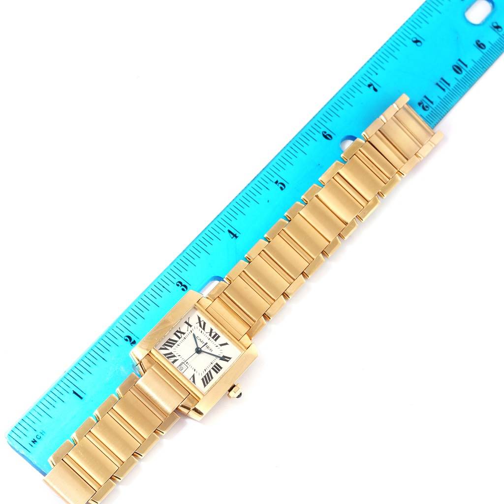 The Tank Francaise model by Cartier is shown from the top view, displaying its face, bracelet, and a measuring ruler.