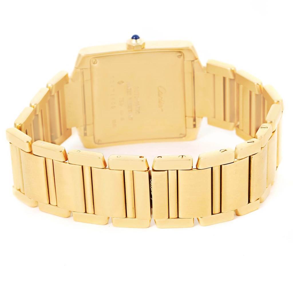 The image shows the back of a Cartier Tank Francaise W50001R2 Yellow Gold Silver Dial W50001R2 Yellow Gold Silver Dial watch, highlighting its gold case and bracelet.
