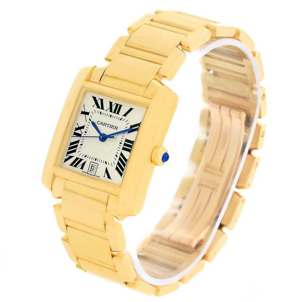 The Cartier Tank Francaise W50001R2 Yellow Gold Silver Dial W50001R2 Yellow Gold Silver Dial watch is pictured at an angle showing the dial, bracelet, and crown with its blue cabochon.