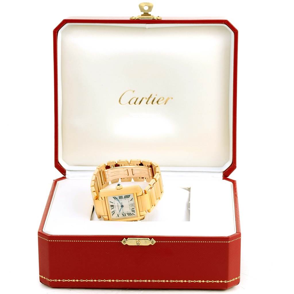The Cartier Tank Française watch is displayed in an open red box, showing its face and a portion of the band.