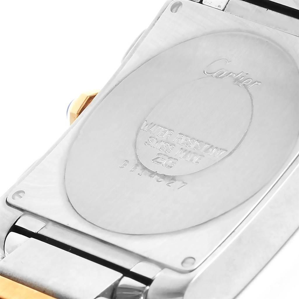 This is the backside of a Cartier Tank Francaise W51004Q4 Men's Steel and Gold (two tone) Silver Dial W51004Q4 Men's Steel and Gold (two tone) Silver Dial watch, displaying the engravings and part of the band.