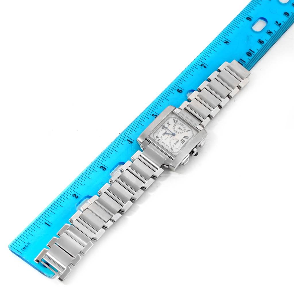 The Cartier Tank Francaise W51001Q3 Men's Stainless Steel White Dial W51001Q3 Men's Stainless Steel White Dial watch is shown from a top-down angle, displaying the face and entire bracelet next to a blue ruler for scale.