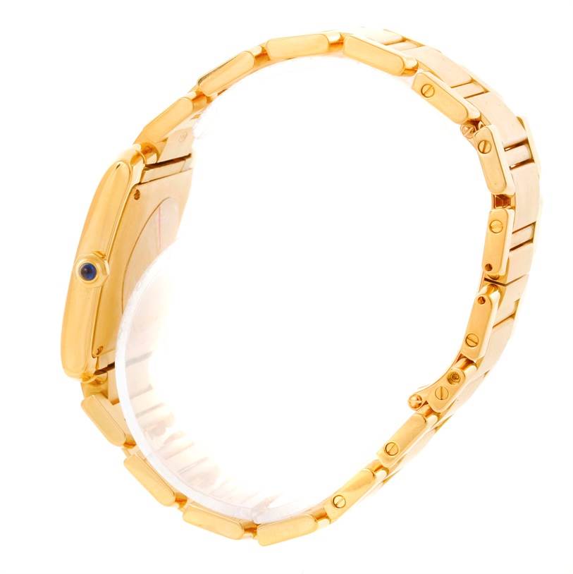 This Cartier Tank Française watch is shown from a side angle, displaying the gold bracelet and crown with a gemstone.