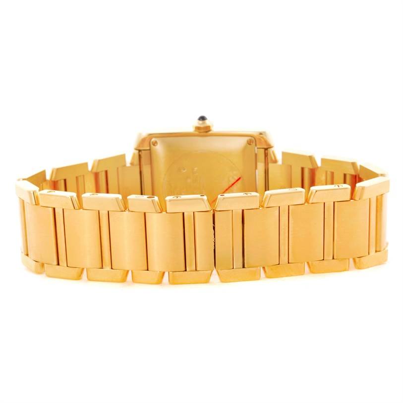 The image shows the rear view of a Tank Francaise model by Cartier, focusing on the gold bracelet links and case back.