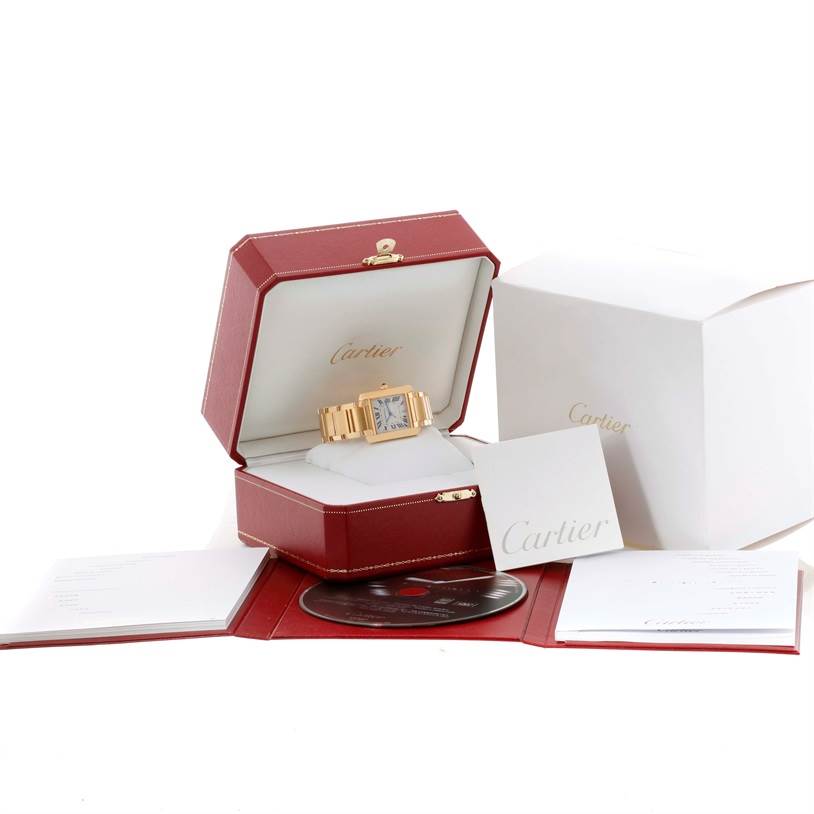 The Cartier Tank Francaise W50001R2 Men
s Yellow Gold Silver Dial W50001R2 Men
s Yellow Gold Silver Dial watch is displayed in its open box, accompanied by manuals, a CD, and additional packaging.