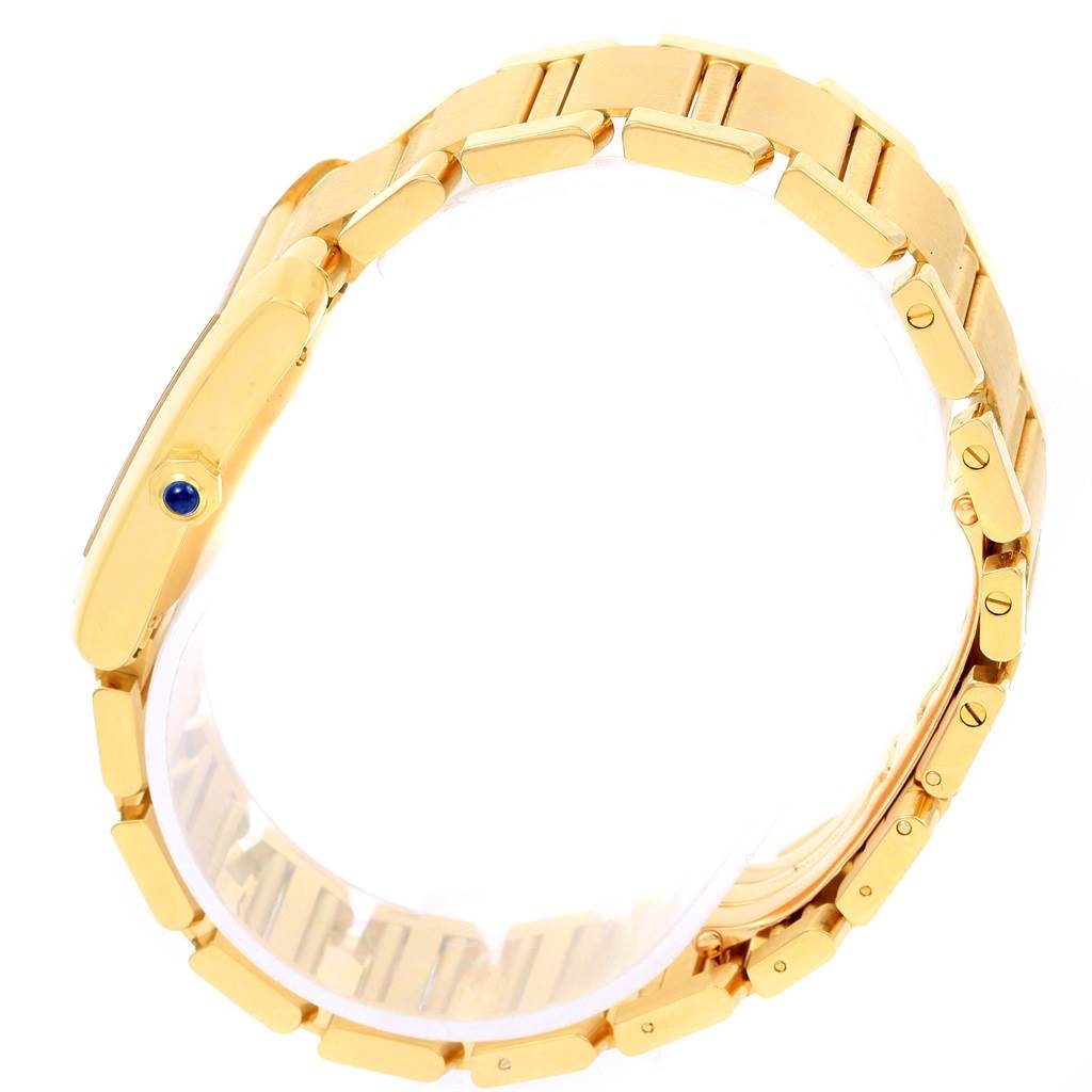 The image shows a side profile of the Tank Francaise by Cartier, highlighting its gold bracelet and blue cabochon crown.