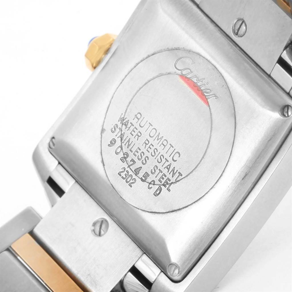 The image shows the back case of a Cartier Tank Française watch, highlighting the engravings and parts of the metal bracelet.