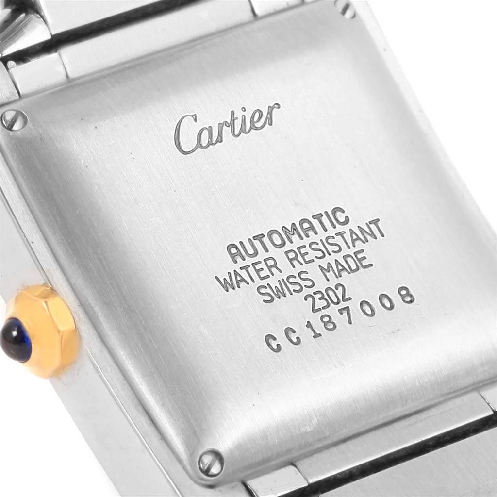 This image shows the back casing and a part of the bracelet of the Tank Francaise model by Cartier, highlighting its inscriptions.