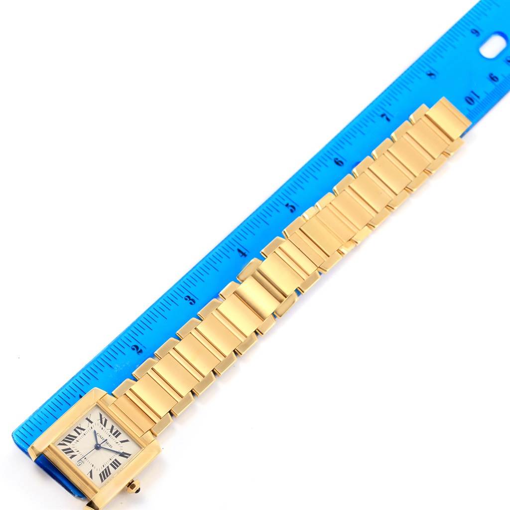 The Cartier Tank Francaise W50001R2 Yellow Gold Silver Dial W50001R2 Yellow Gold Silver Dial watch is shown from a top view, highlighting its bracelet and rectangular watch face.