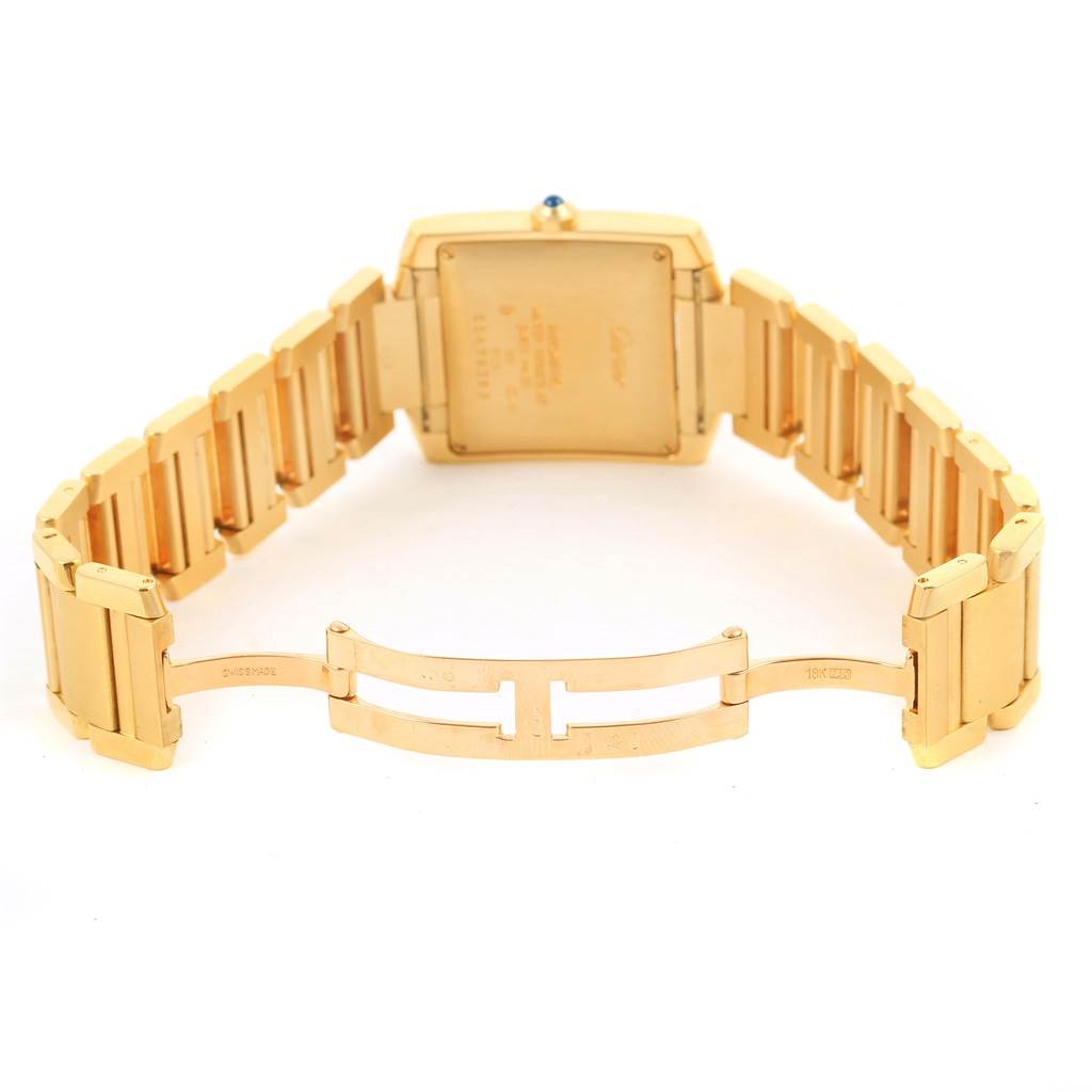 This image shows the back and open clasp of a Cartier Tank Francaise W50001R2 Yellow Gold Silver Dial W50001R2 Yellow Gold Silver Dial watch, highlighting its gold bracelet.