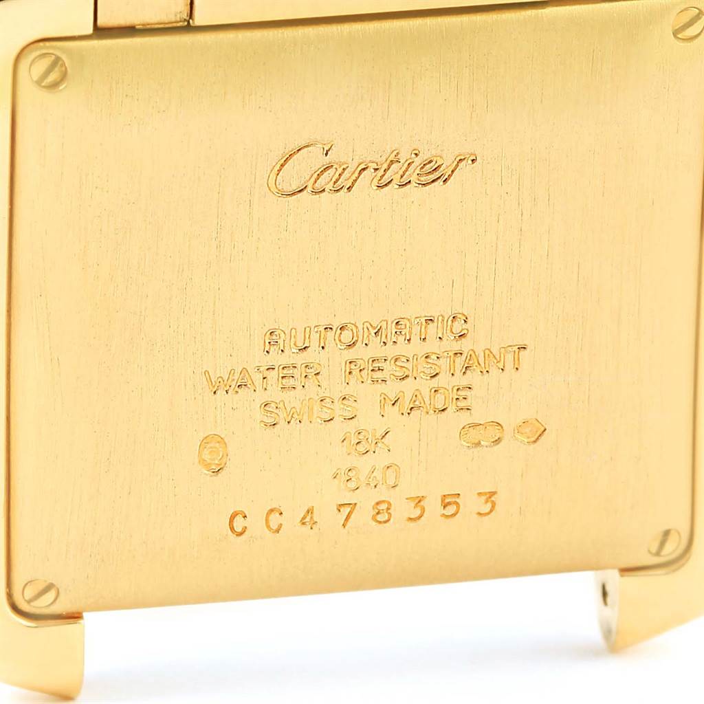 This image shows the engraved backplate of a Cartier Tank Francaise W50001R2 Yellow Gold Silver Dial W50001R2 Yellow Gold Silver Dial watch, displaying details like material and serial number.