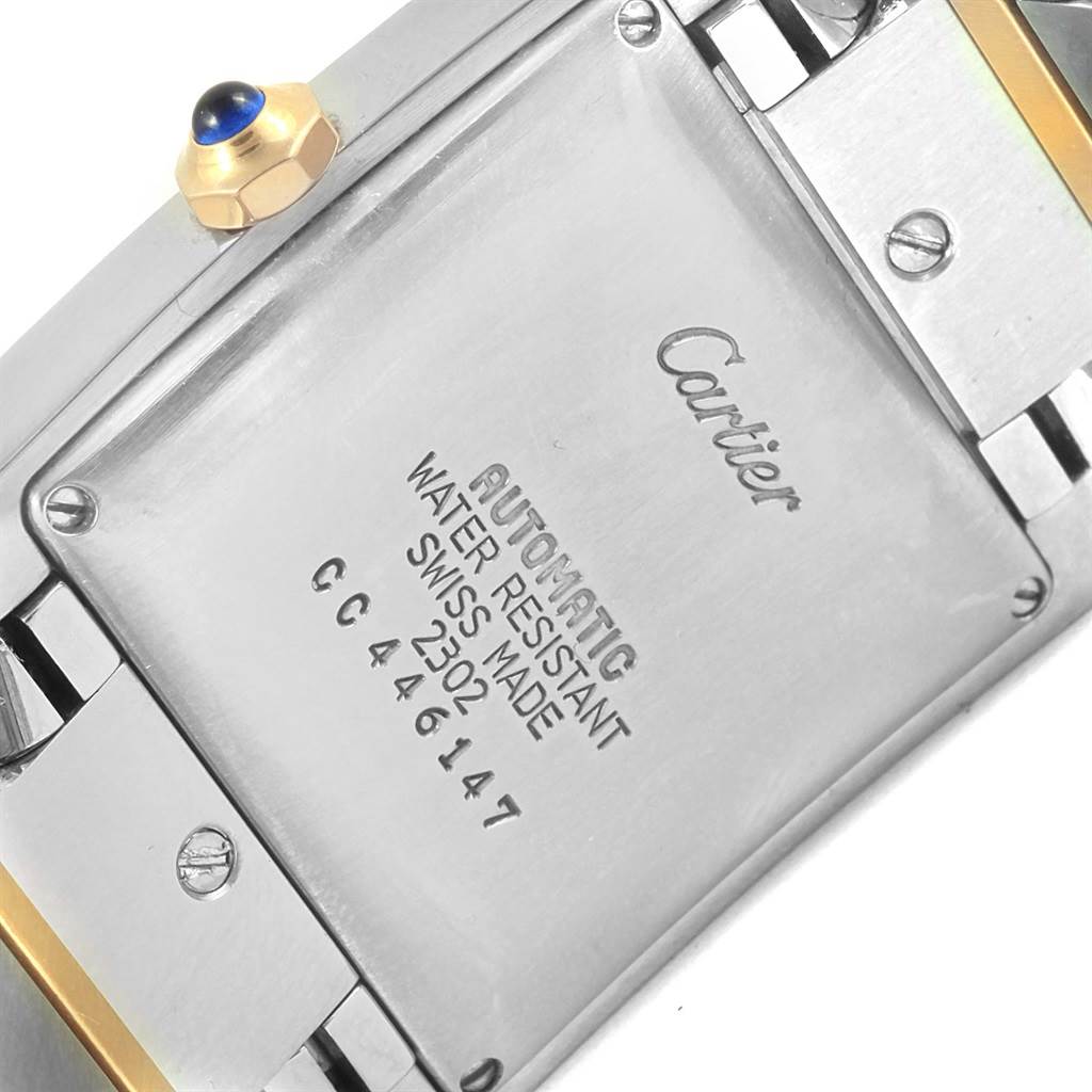 This image shows the back case and crown of a Cartier Tank Française watch.
