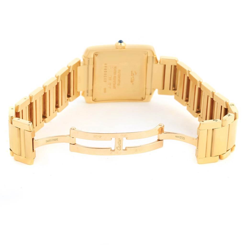 This Cartier Tank Francaise W50001R2 Men's Yellow Gold Silver Dial W50001R2 Men's Yellow Gold Silver Dial watch is shown from the rear, highlighting the case back and partially open bracelet.