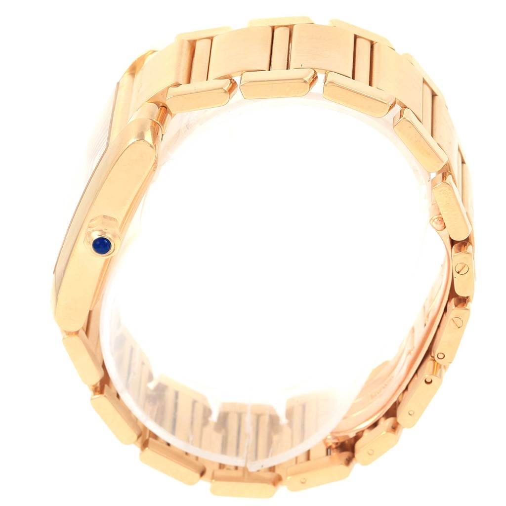 The image shows a side view of a Tank Francaise model by Cartier, highlighting the gold bracelet and crown with a blue cabochon.