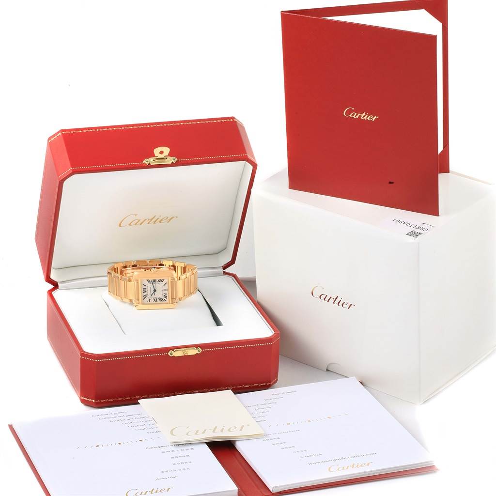 The Cartier Tank Francaise W50001R2 Men's Yellow Gold Silver Dial W50001R2 Men's Yellow Gold Silver Dial watch is shown from a top angle in its open case with accompanying booklets and packaging.