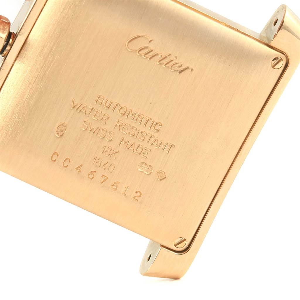 This image shows the back case of a Cartier Tank Francaise W50001R2 Men's Yellow Gold Silver Dial W50001R2 Men's Yellow Gold Silver Dial watch in a close-up angle, highlighting its engravings and details.